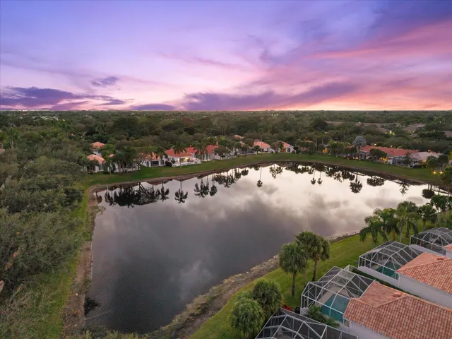 a view of a lake with houses in back