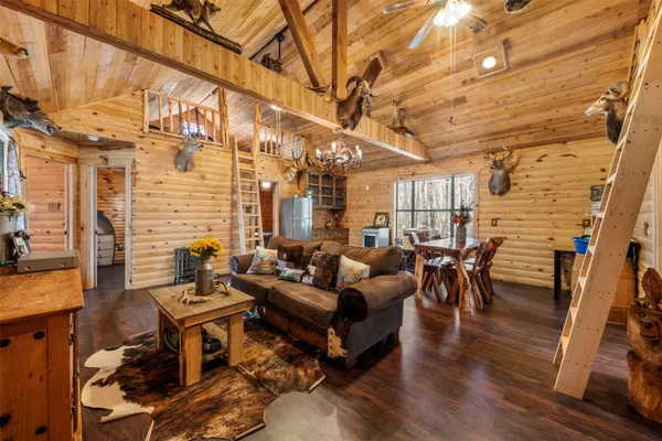 a living room with fireplace furniture and a wooden floor