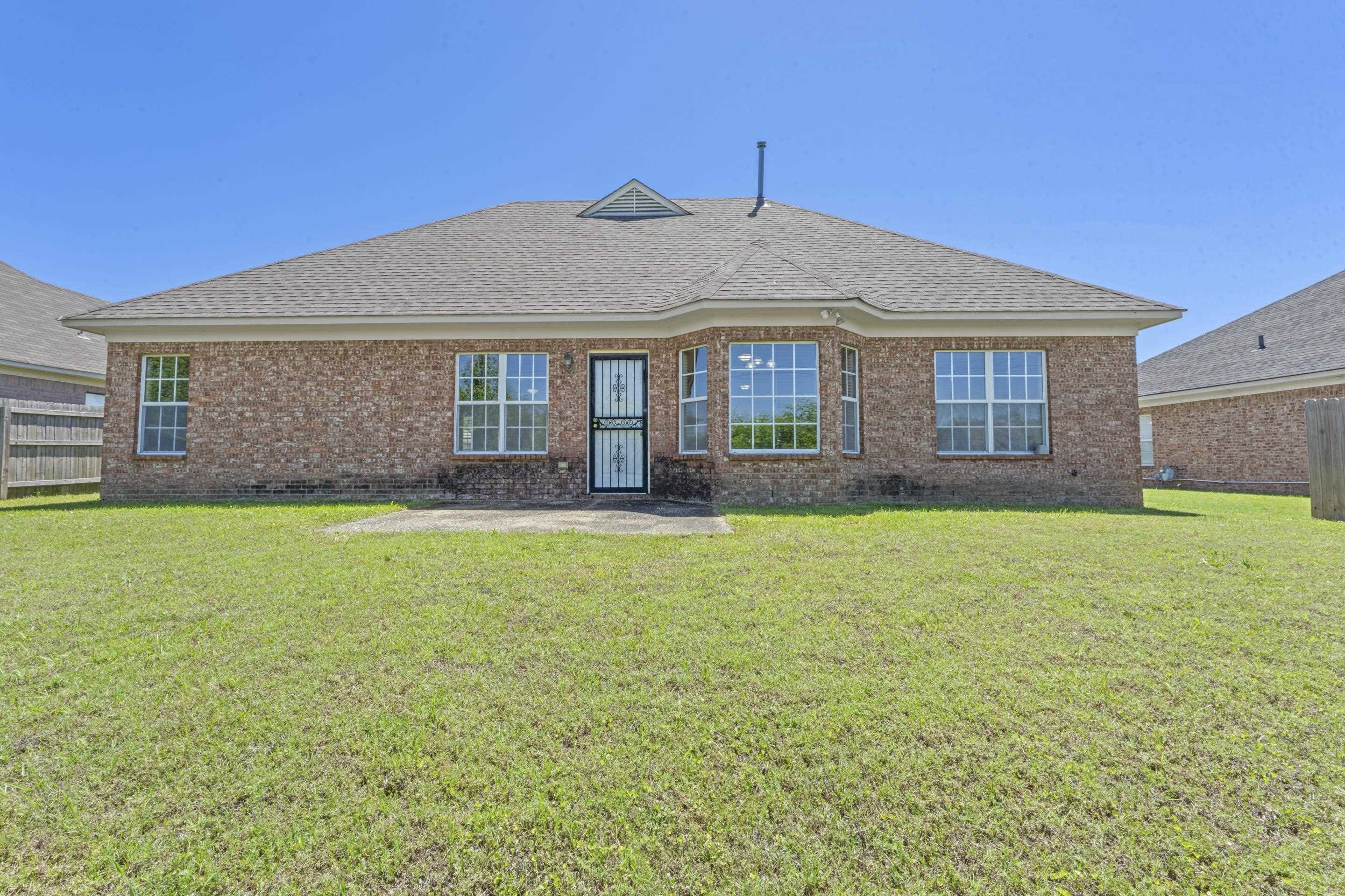 50 Abbey Road Oakland, TN 38060 - Photo 25 of 26 Expansive rear exterior featuring a brick facade and a wide lawn