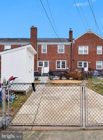 a view of a brick building next to a yard