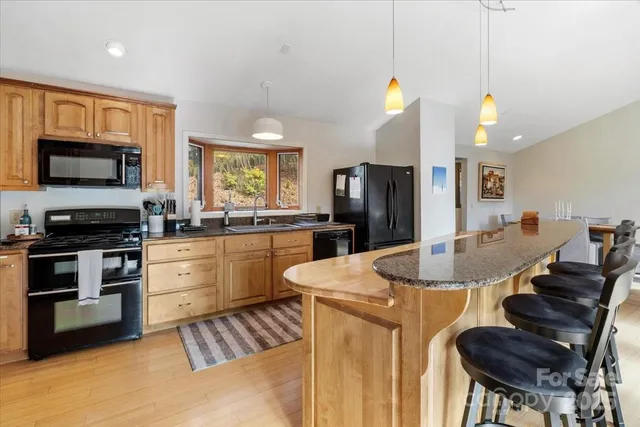 a kitchen with granite countertop a stove and a microwave