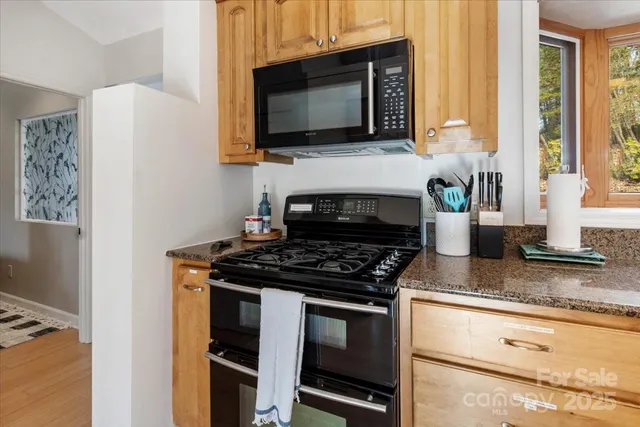 a kitchen with stainless steel appliances a refrigerator and a stove