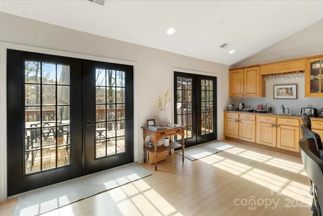 a spacious bathroom with a tub double sink and a mirror