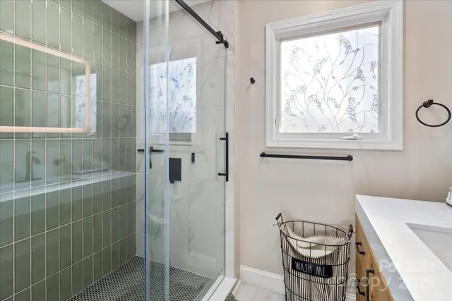 a bathroom with a sink a window and a mirror