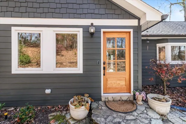 a view of room with window and front door