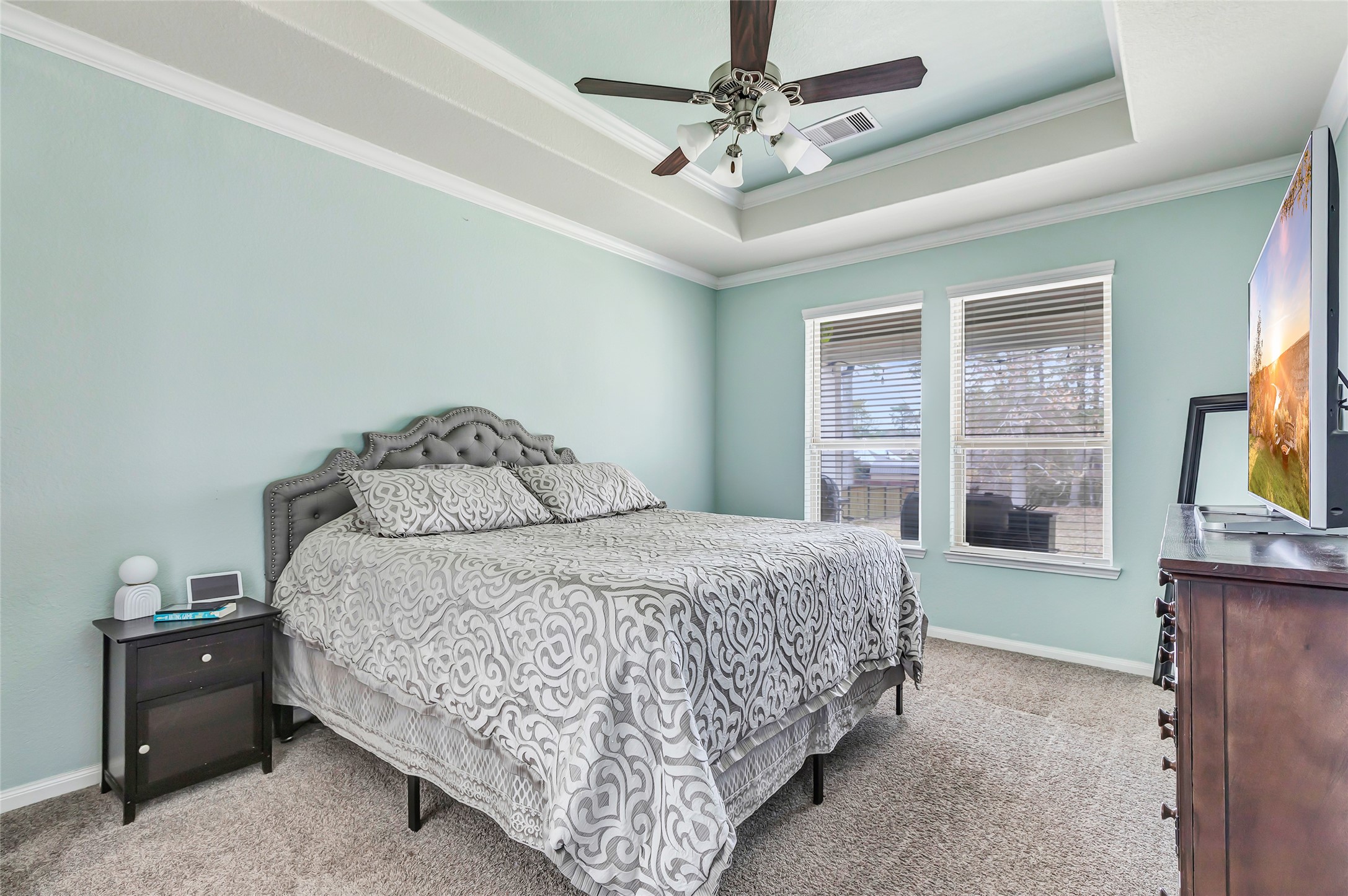 28511 Riverside Crest Lane Houston, TX 77336 - Photo 25 of 41 a bedroom with a bed and a flat tv screen on dresser
