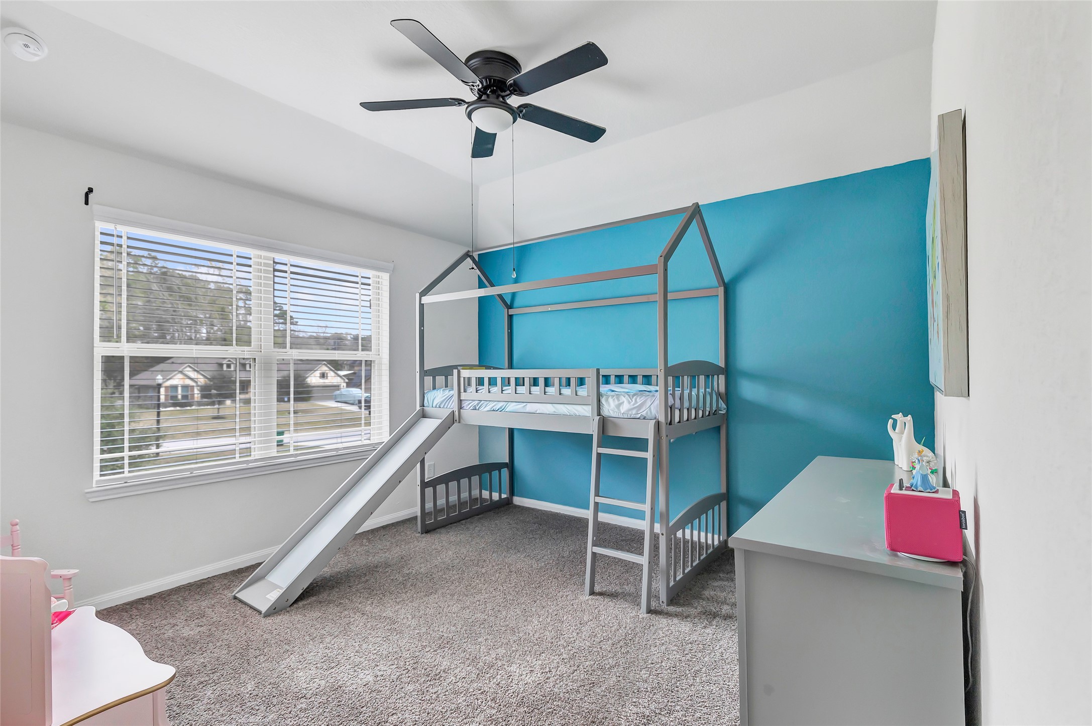28511 Riverside Crest Lane Houston, TX 77336 - Photo 33 of 41 a bedroom with a bed and a chandelier