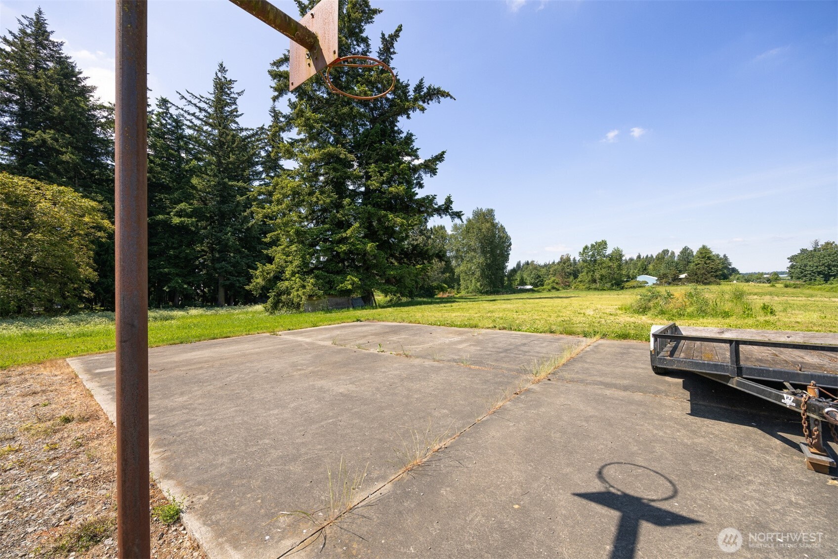 6791 Noon Road Everson, WA 98247 - Photo 35 of 38 a view of swimming pool with seating area and trees in the background