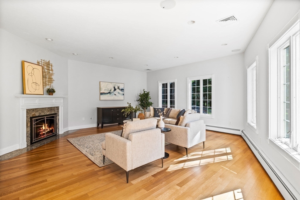 1 Fox Hunt Lane Winchester, MA 01890 - Photo 14 of 38 a living room with furniture a fireplace and a large window