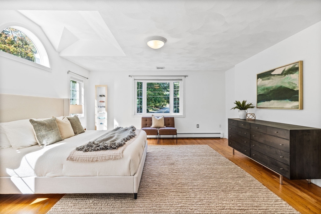 1 Fox Hunt Lane Winchester, MA 01890 - Photo 21 of 38 a bedroom with a bed and a flat tv screen on dresser