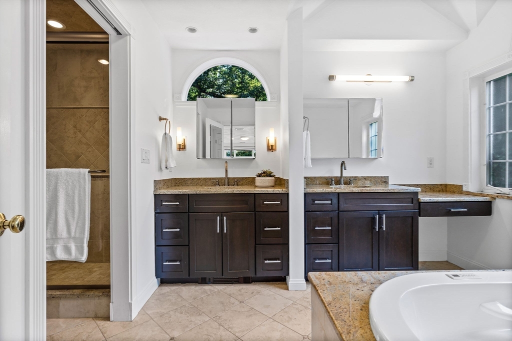 1 Fox Hunt Lane Winchester, MA 01890 - Photo 22 of 38 a spacious bathroom with a granite countertop tub sink and mirror