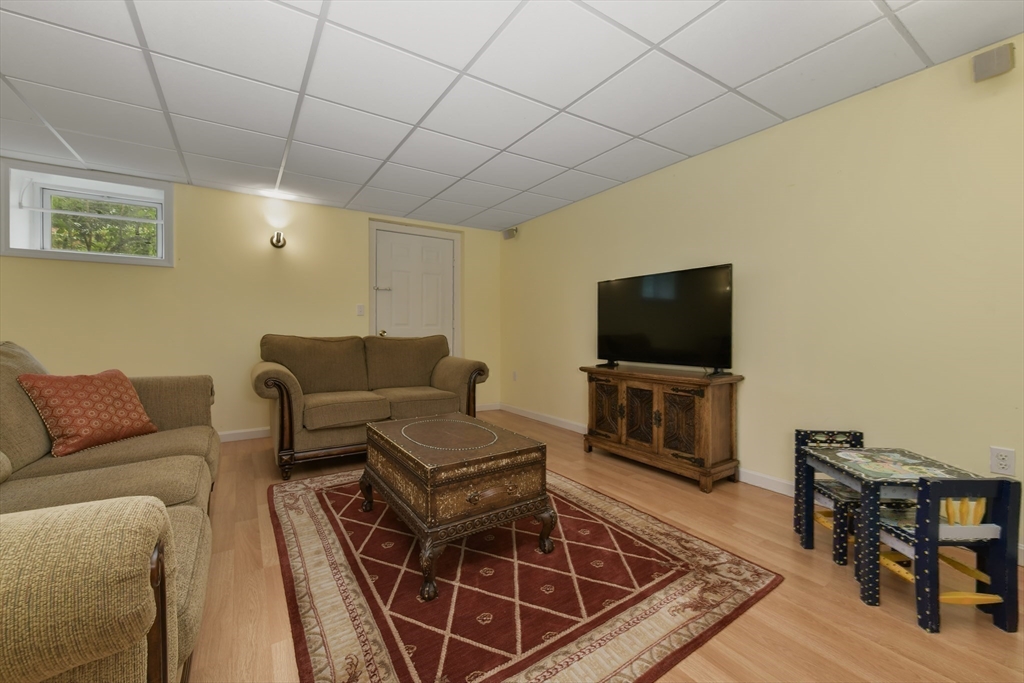 1 Fox Hunt Lane Winchester, MA 01890 - Photo 28 of 38 a living room with furniture and a flat screen tv