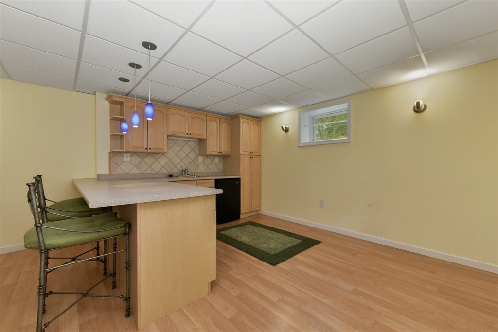 1 Fox Hunt Lane Winchester, MA 01890 - Photo 30 of 38 a kitchen with a sink cabinets and wooden floor