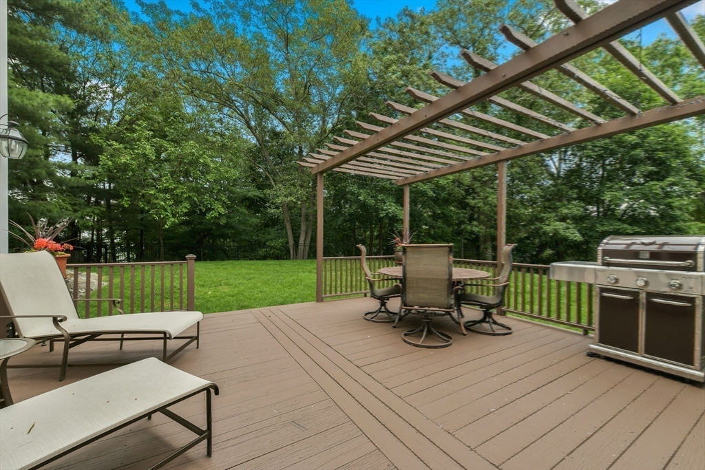 1 Fox Hunt Lane Winchester, MA 01890 - Photo 31 of 38 a view of backyard with a table and chairs