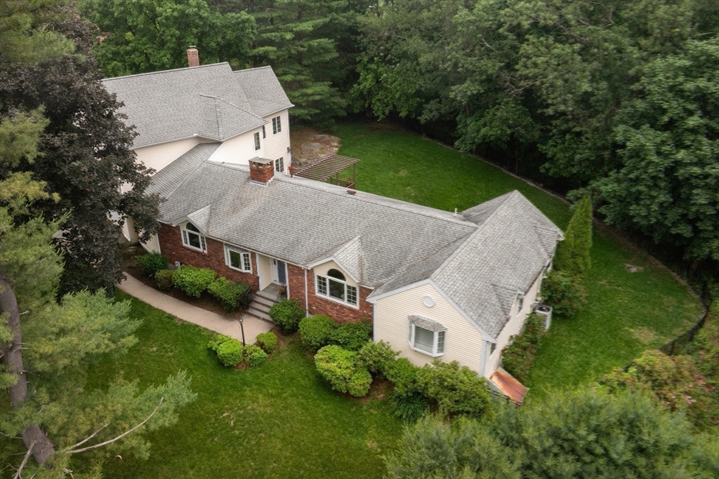 1 Fox Hunt Lane Winchester, MA 01890 - Photo 33 of 38 an aerial view of a house with a yard table and chairs