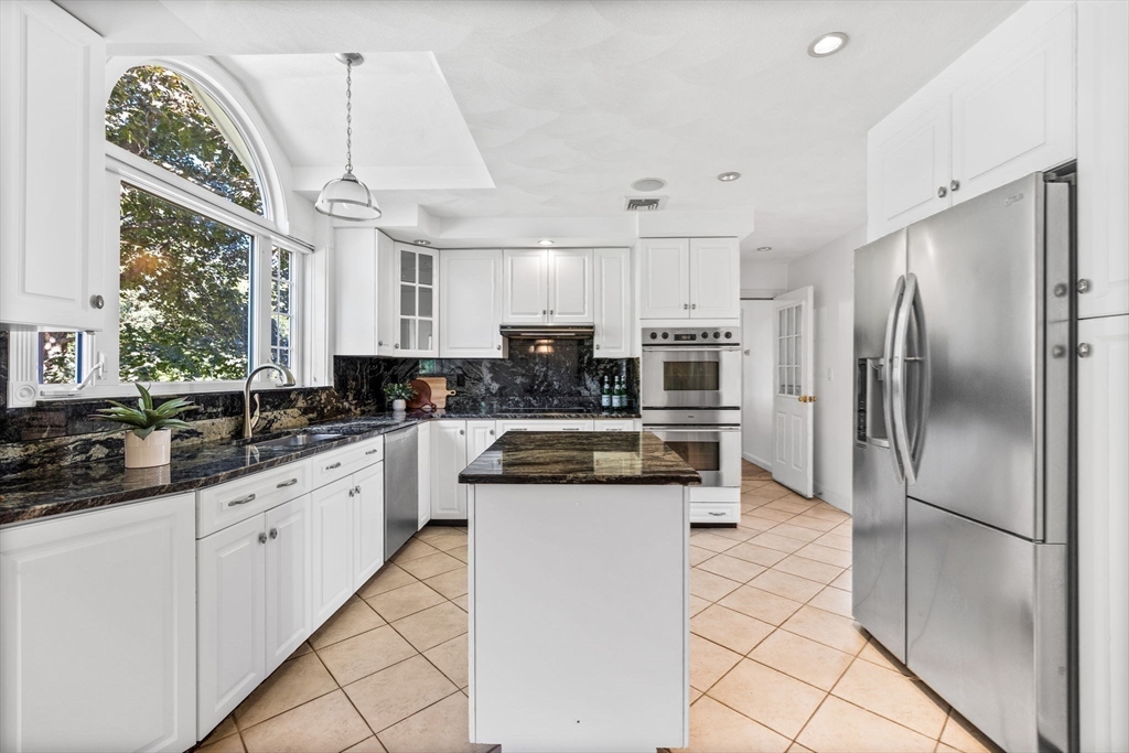 1 Fox Hunt Lane Winchester, MA 01890 - Photo 5 of 38 a kitchen with stainless steel appliances a refrigerator sink and microwave