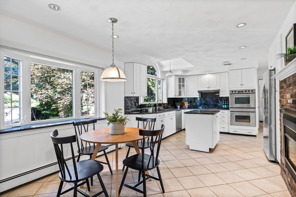 1 Fox Hunt Lane Winchester, MA 01890 - Photo 9 of 38 a dining room with furniture a window and kitchen view
