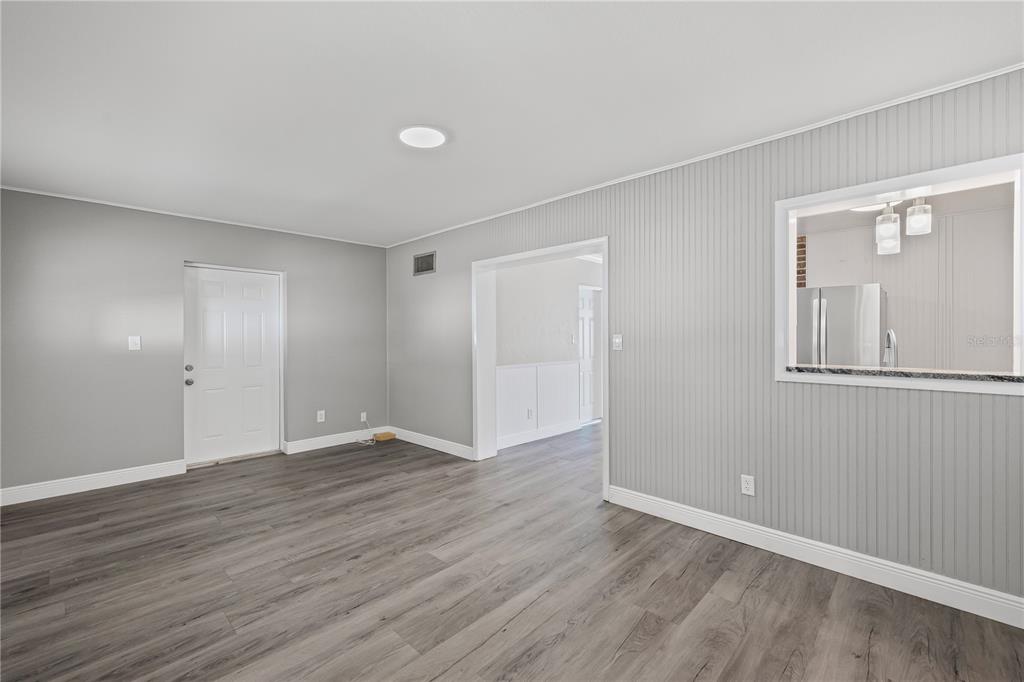5046 99th Way North St. Petersburg, FL 33708 - Photo 14 of 41 a view of an empty room with wooden floor and closet