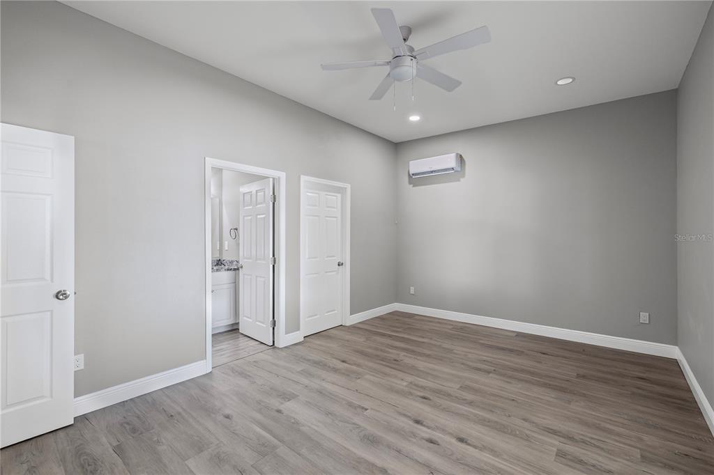 5046 99th Way North St. Petersburg, FL 33708 - Photo 16 of 41 an empty room with wooden floor and ceiling fan
