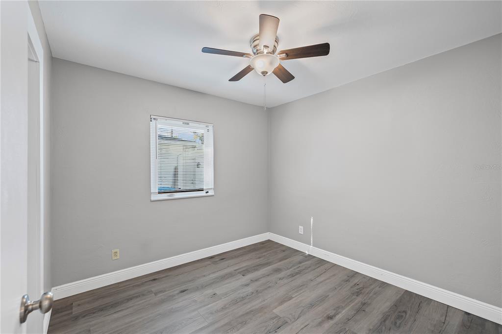 5046 99th Way North St. Petersburg, FL 33708 - Photo 18 of 41 a view of an empty room with wooden floor