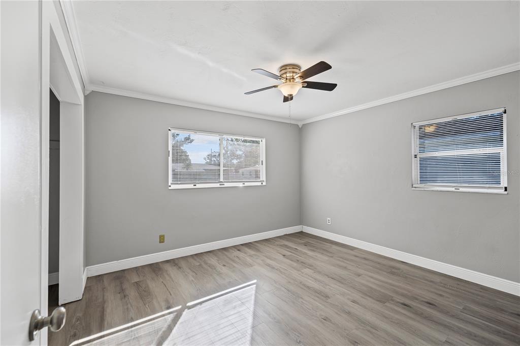 5046 99th Way North St. Petersburg, FL 33708 - Photo 20 of 41 a view of an empty room with a window and wooden floor