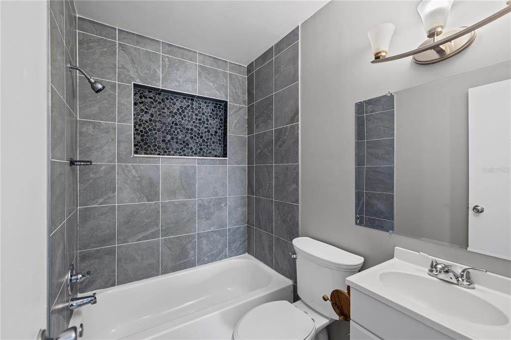 5046 99th Way North St. Petersburg, FL 33708 - Photo 22 of 41 a bathroom with a sink toilet and shower