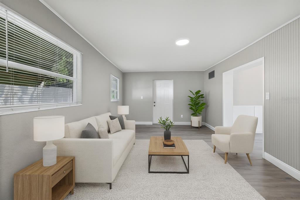 5046 99th Way North St. Petersburg, FL 33708 - Photo 4 of 41 a living room with furniture and a large window
