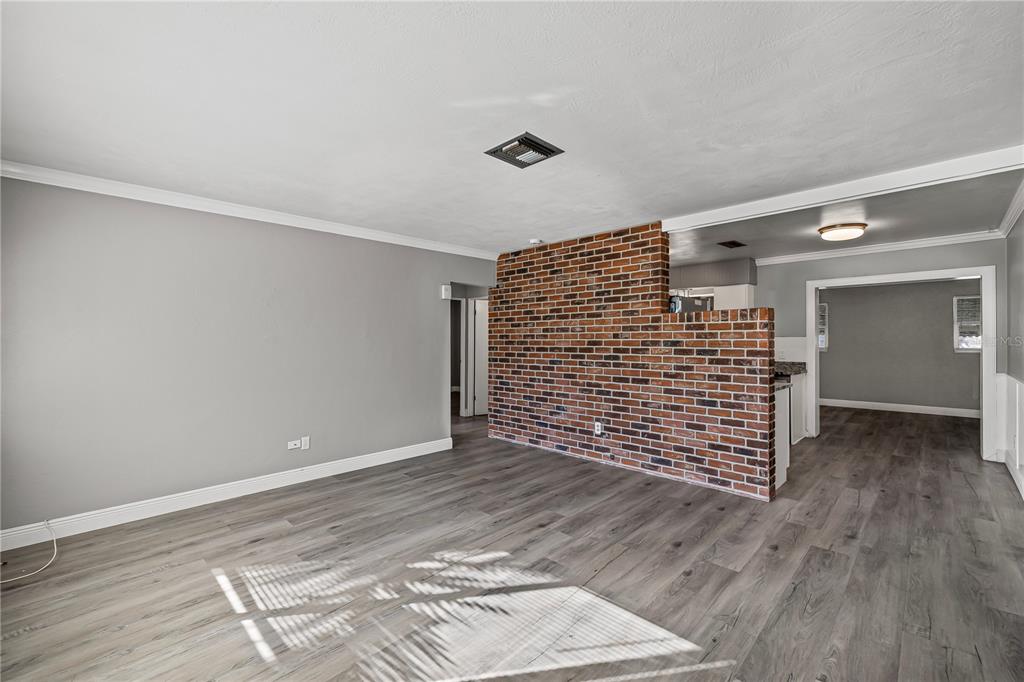 5046 99th Way North St. Petersburg, FL 33708 - Photo 7 of 41 a view of an empty room with wooden floor