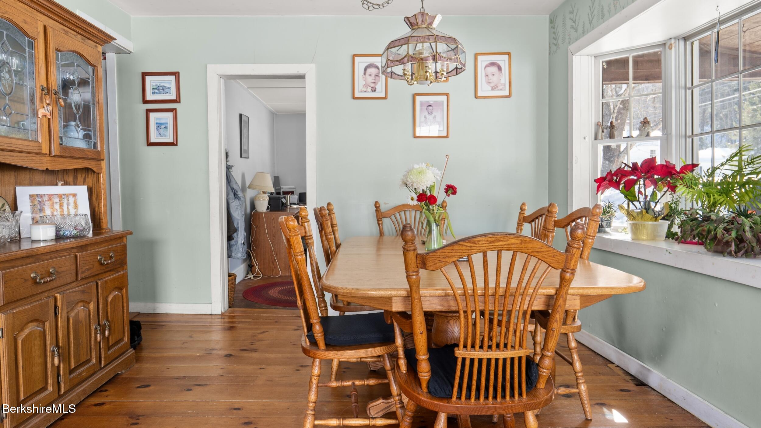 93 South Main Road Otis, MA 01253 - Photo 12 of 27 a view of a dining room with furniture wooden floor and a chandelier