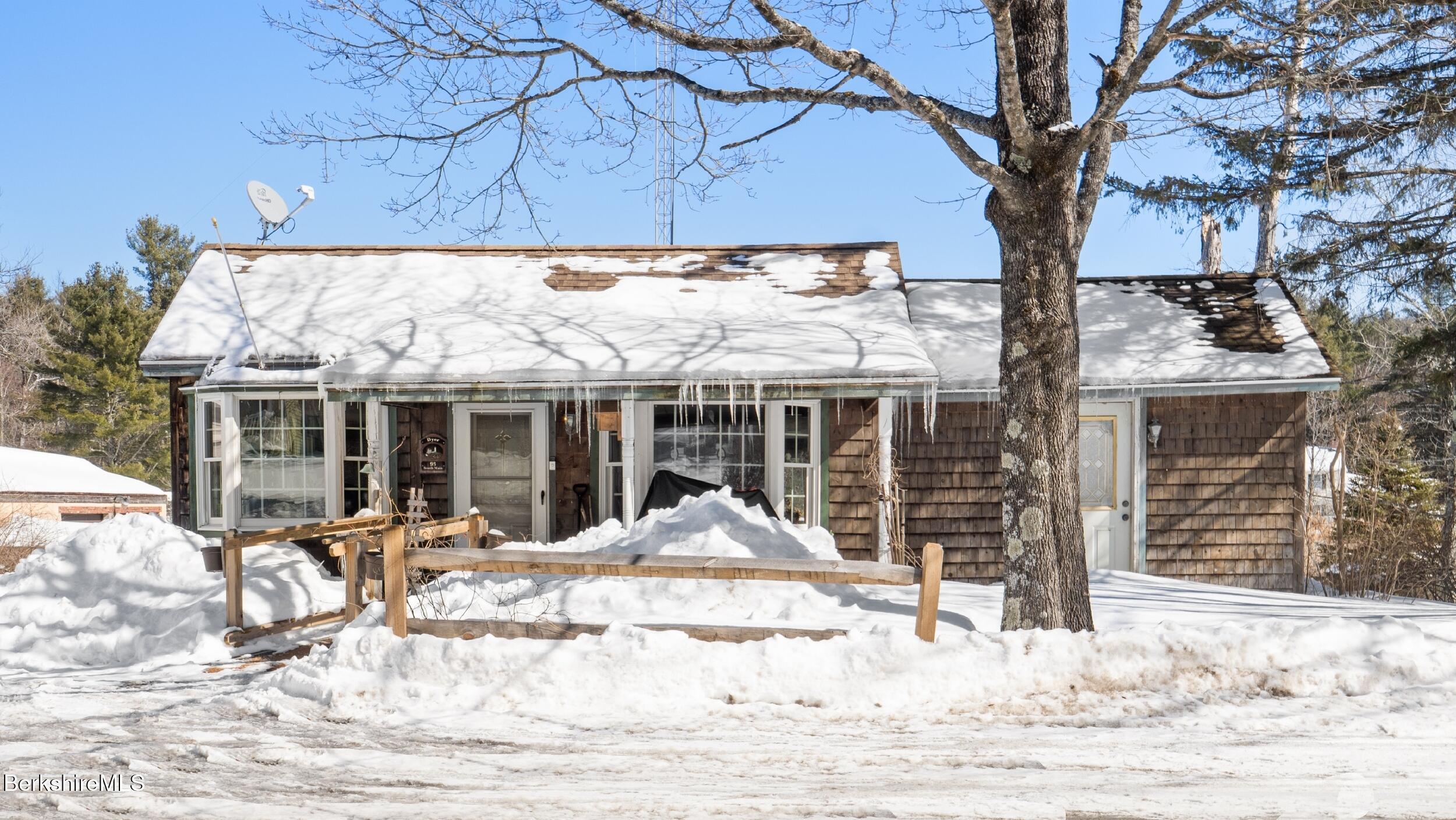 93 South Main Road Otis, MA 01253 - Photo 3 of 27 a view of a house with a yard covered in snow