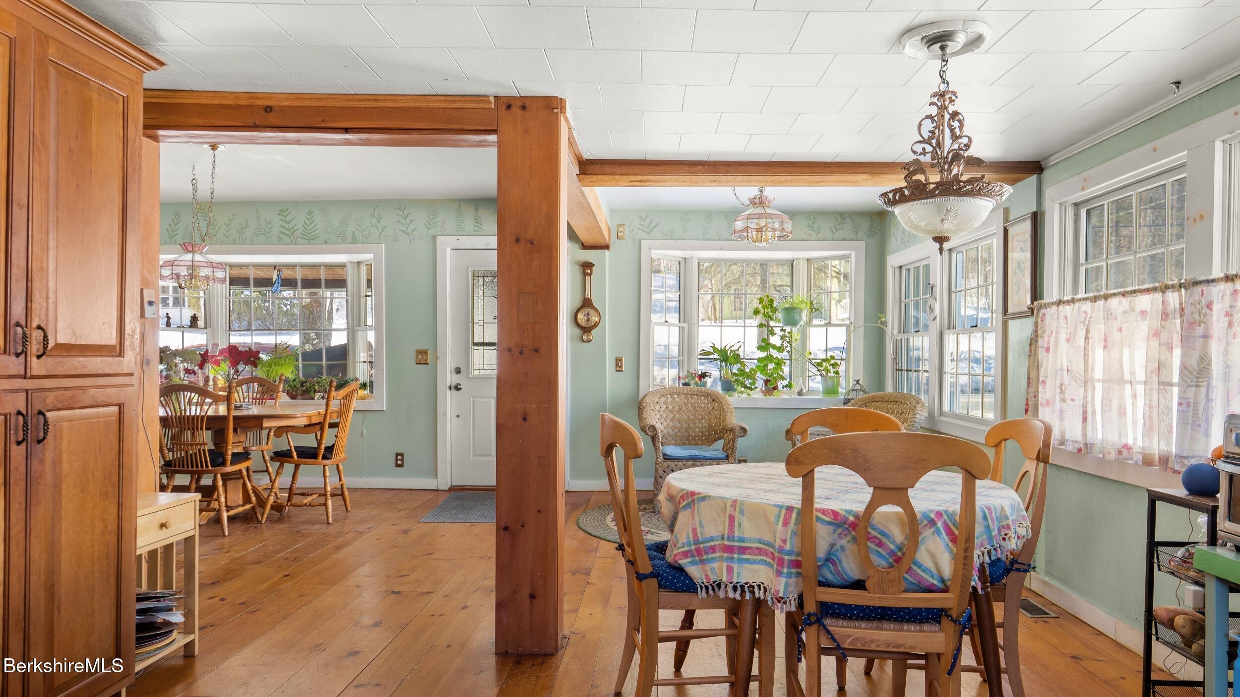 93 South Main Road Otis, MA 01253 - Photo 9 of 27 a dining room with furniture wooden floor a chandelier