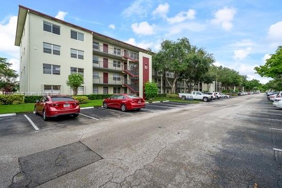 13255 Southwest 7th Court, Unit 403D Pembroke Pines, FL 33027 - Photo 2 of 19 a car parked in front of a building