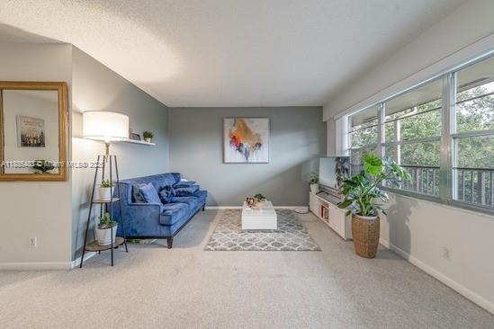 13255 Southwest 7th Court, Unit 403D Pembroke Pines, FL 33027 - Photo 7 of 19 a living room with furniture and a potted plant