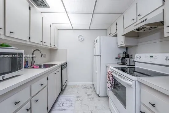 a kitchen with cabinets and steel stainless steel appliances