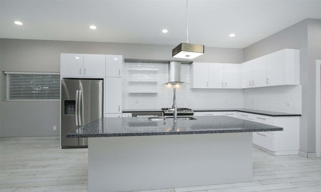 309 East 43rd Street, Unit A Houston, TX 77022 - Photo 11 of 35 a view of a kitchen with a sink stainless steel appliances and cabinets
