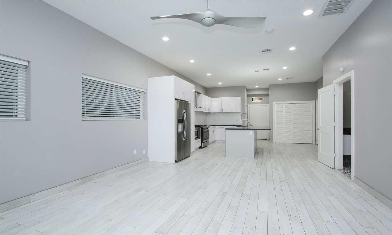 309 East 43rd Street, Unit A Houston, TX 77022 - Photo 17 of 35 a view of kitchen with refrigerator sink and wooden floor