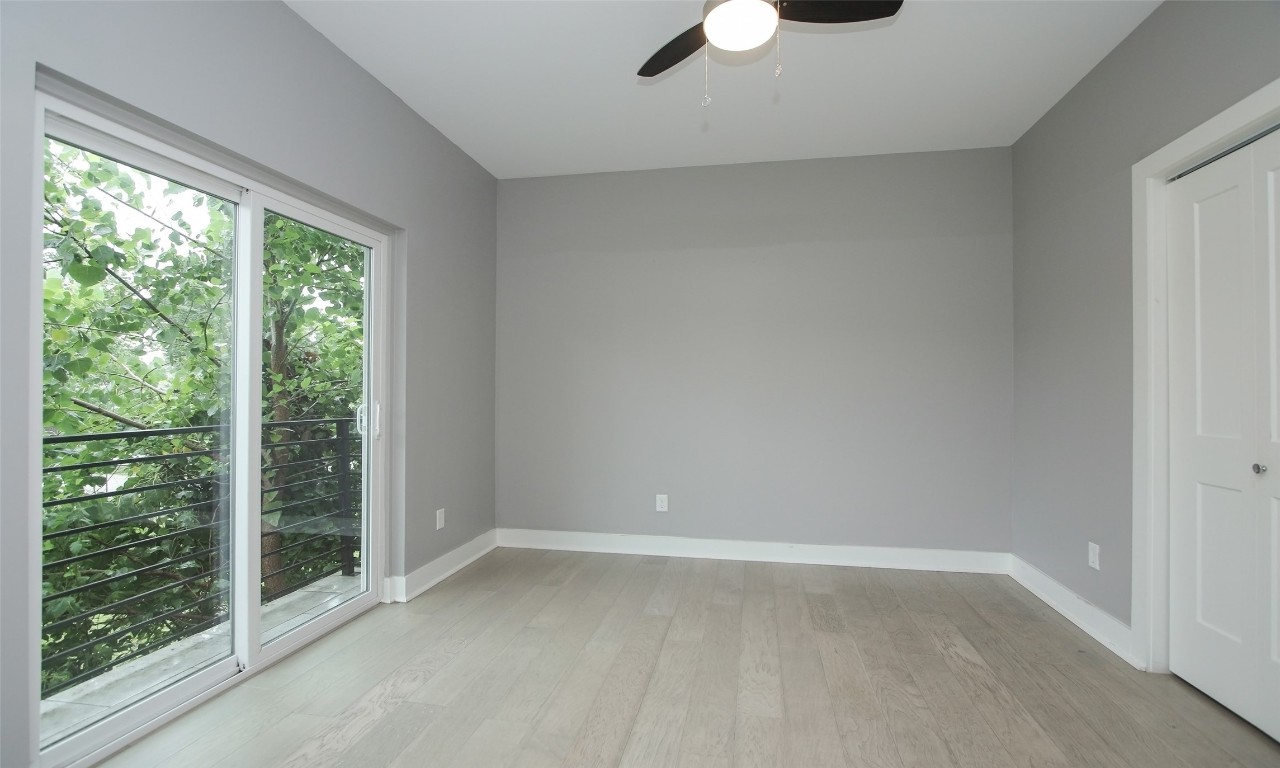 309 East 43rd Street, Unit A Houston, TX 77022 - Photo 30 of 35 a view of an empty room with wooden floor and windows