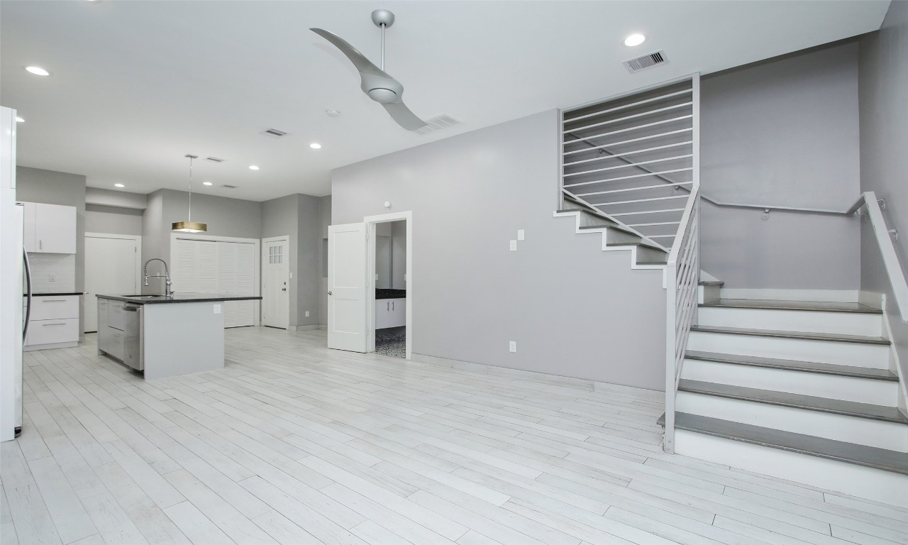 309 East 43rd Street, Unit A Houston, TX 77022 - Photo 3 of 35 a view of an empty room with wooden floor and stairs