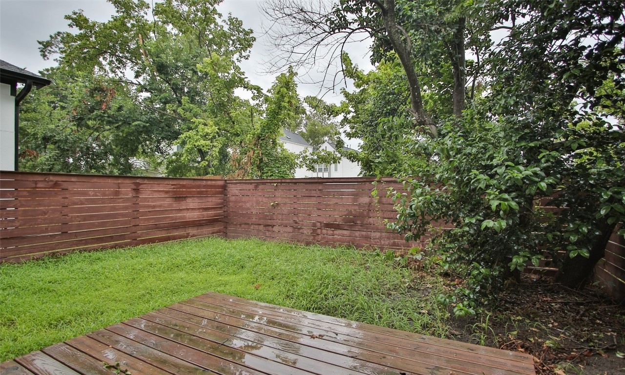 309 East 43rd Street, Unit A Houston, TX 77022 - Photo 35 of 35 a view of a backyard with wooden fence and trees