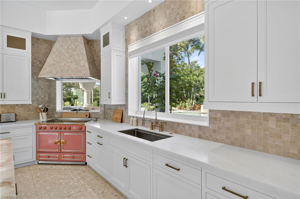 111 Caribbean Road Naples, FL 34108 - Photo 15 of 50 a kitchen with a sink and large window