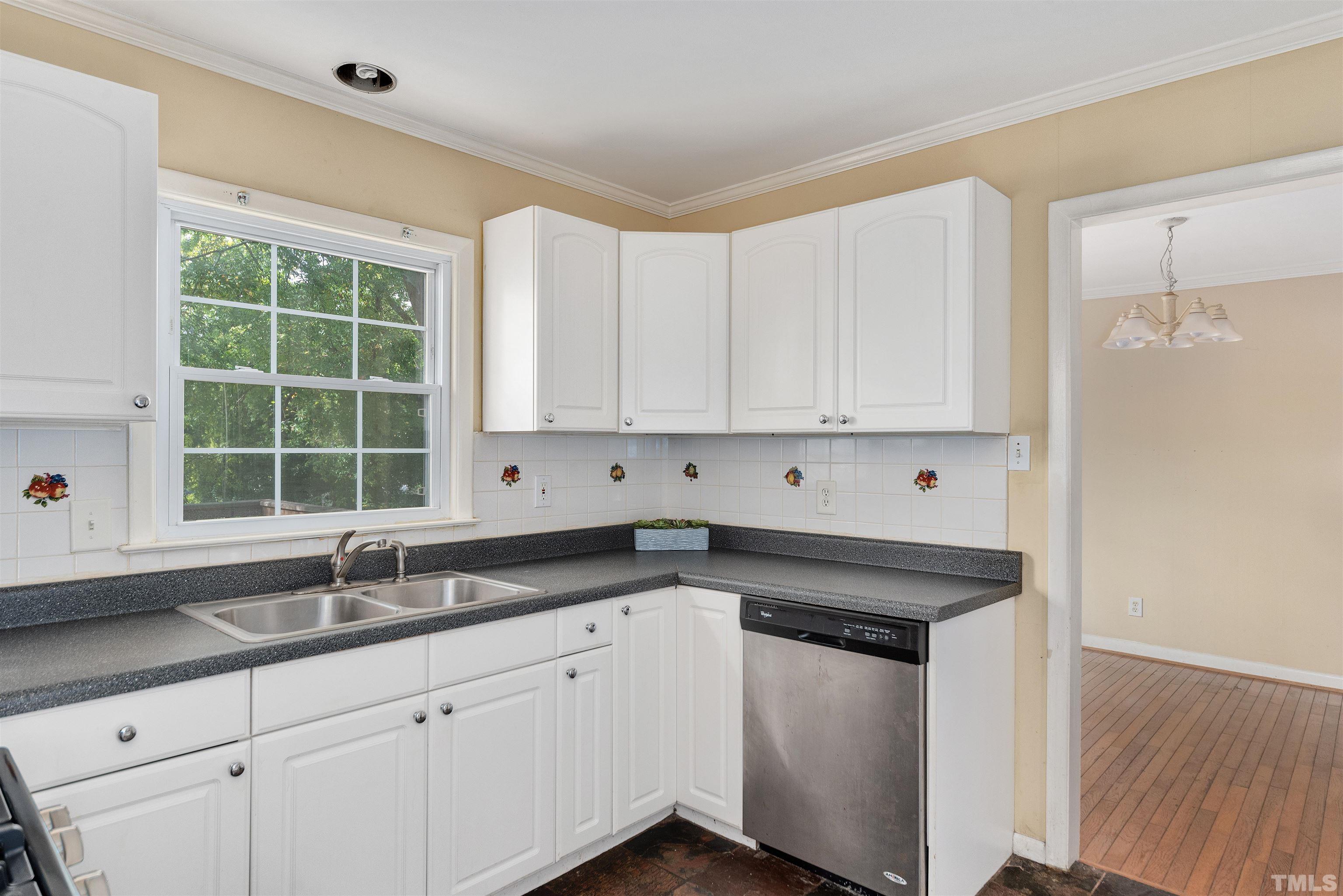 711 Latta Street Raleigh, NC 27607 - Photo 11 of 30 a kitchen with granite countertop white cabinets and sink