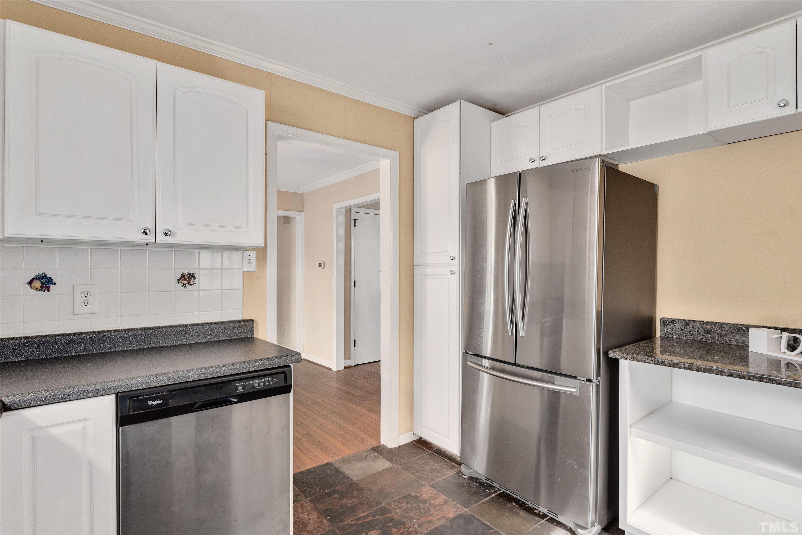 711 Latta Street Raleigh, NC 27607 - Photo 12 of 30 a kitchen with stainless steel appliances a refrigerator and a stove top oven