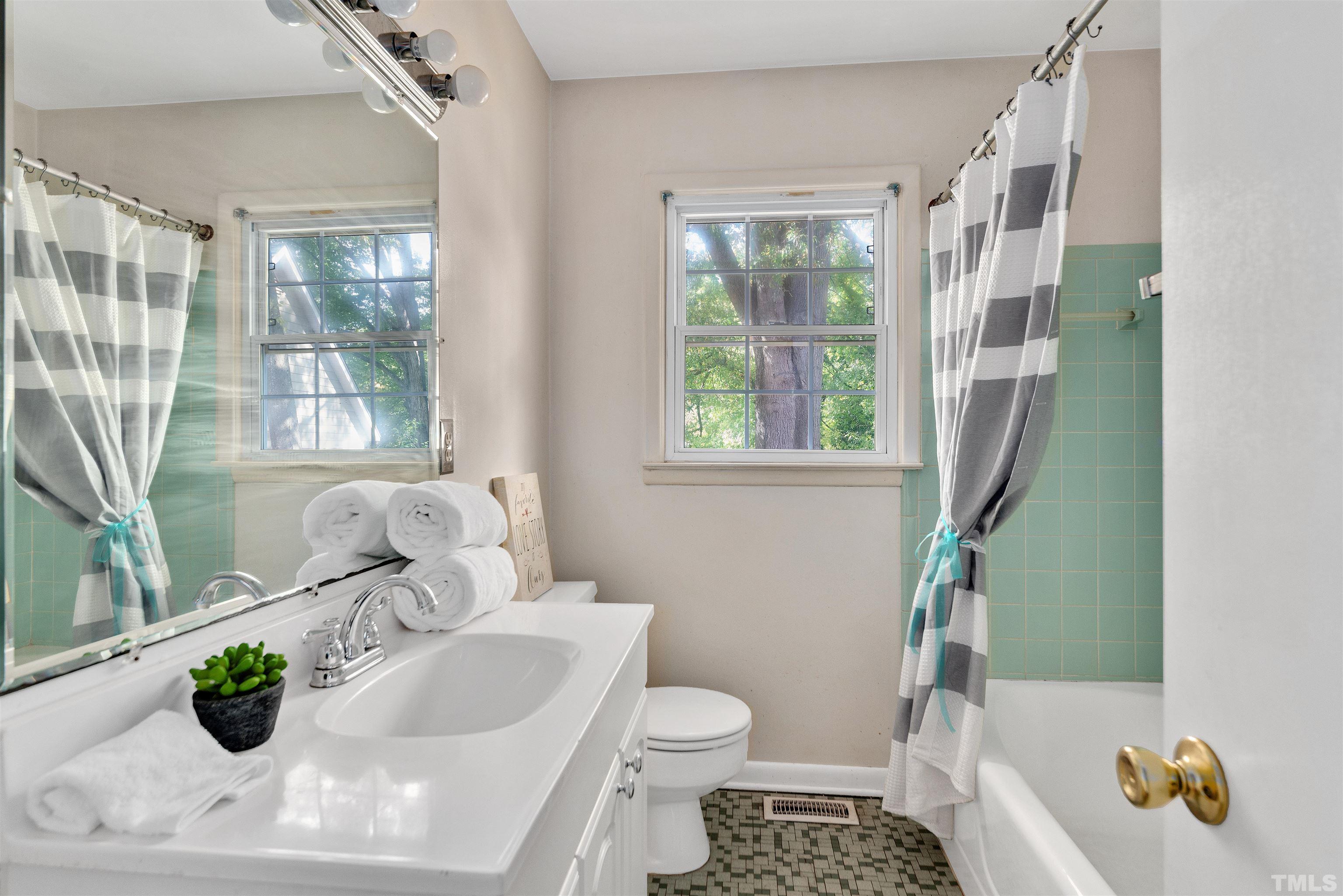 711 Latta Street Raleigh, NC 27607 - Photo 14 of 30 a bathroom with a sink toilet and window