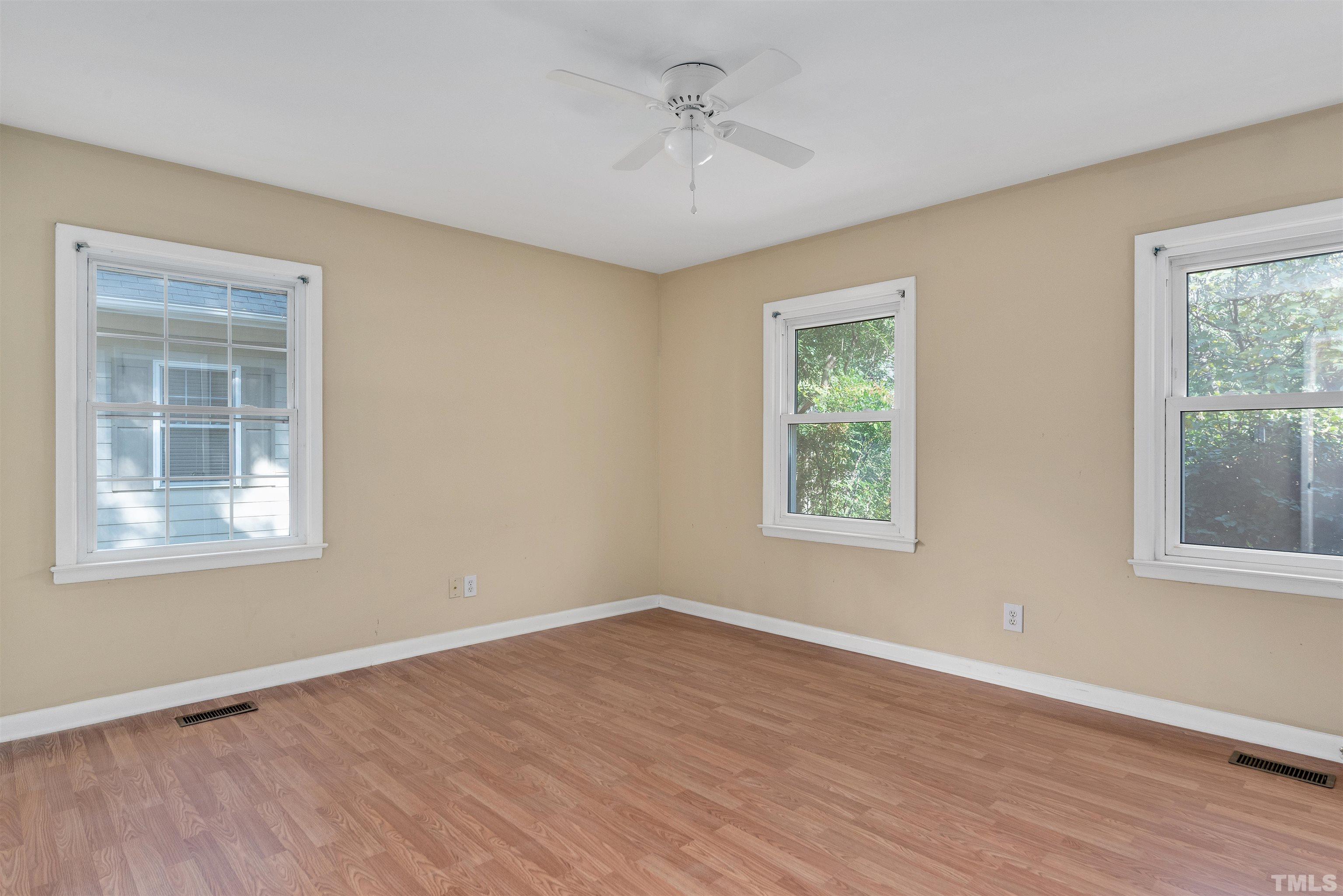 711 Latta Street Raleigh, NC 27607 - Photo 15 of 30 a view of an empty room with wooden floor and a window