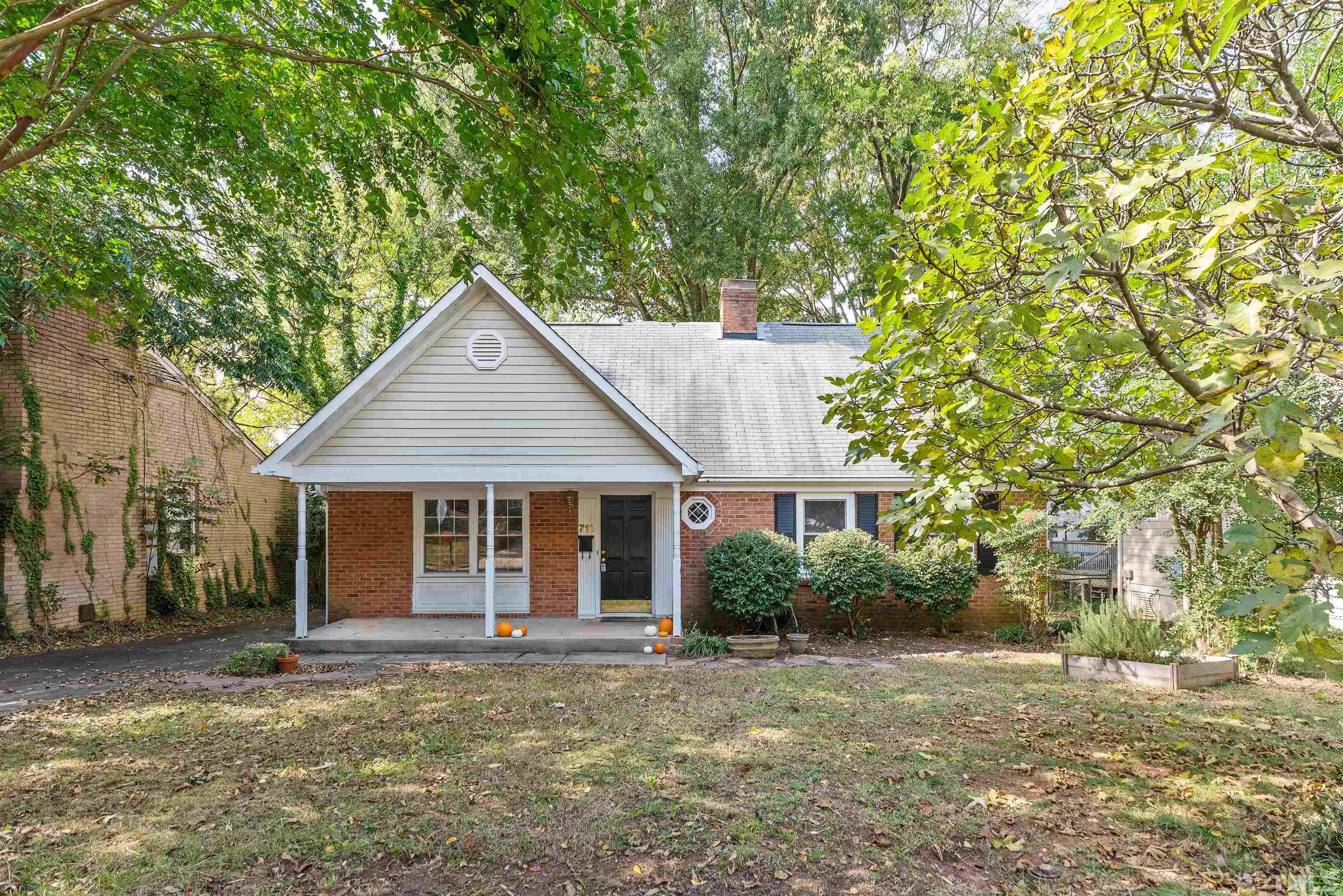 711 Latta Street Raleigh, NC 27607 - Photo 3 of 30 a view of a yard in front of a house with large tree