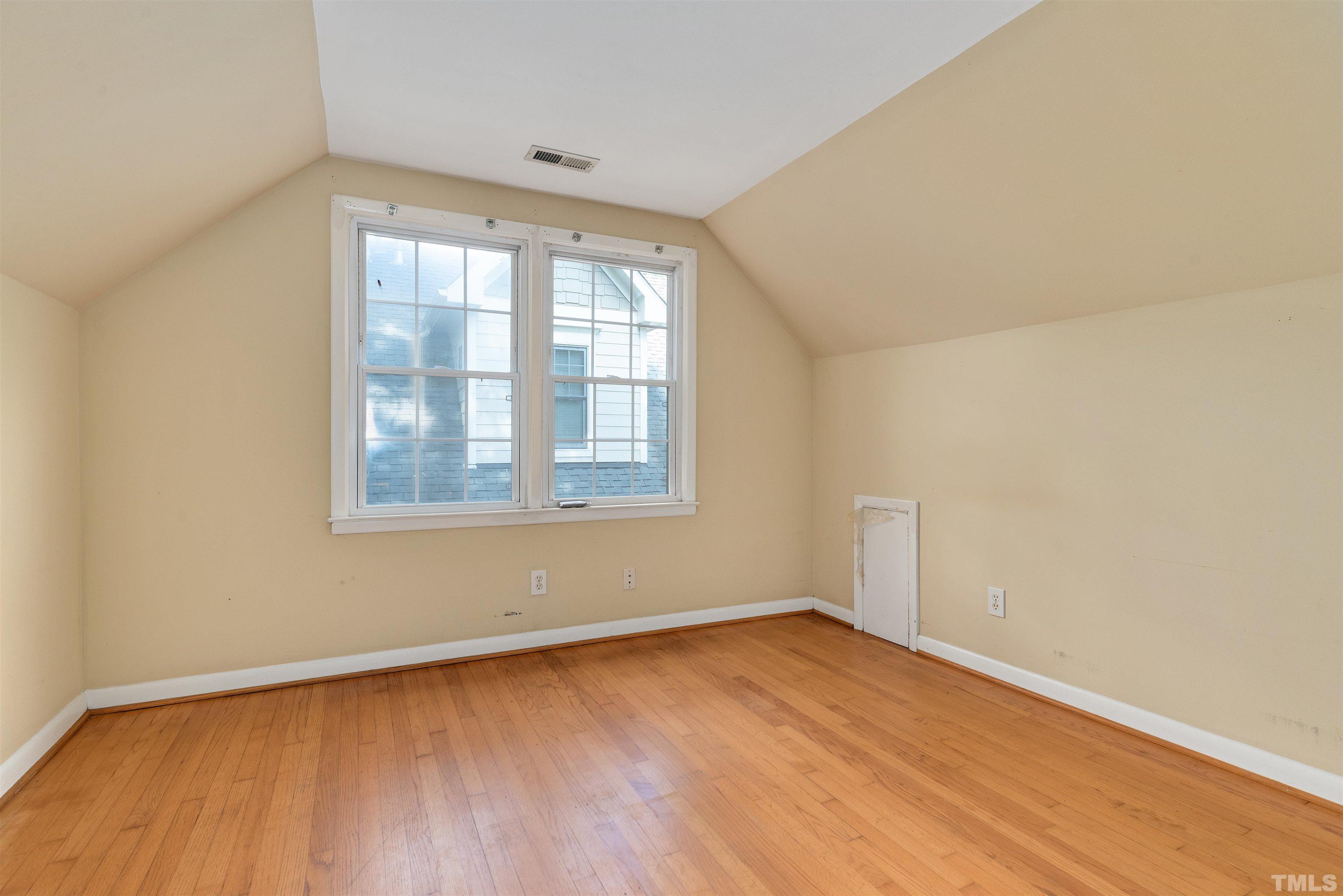 711 Latta Street Raleigh, NC 27607 - Photo 25 of 30 an empty room with wooden floor and windows