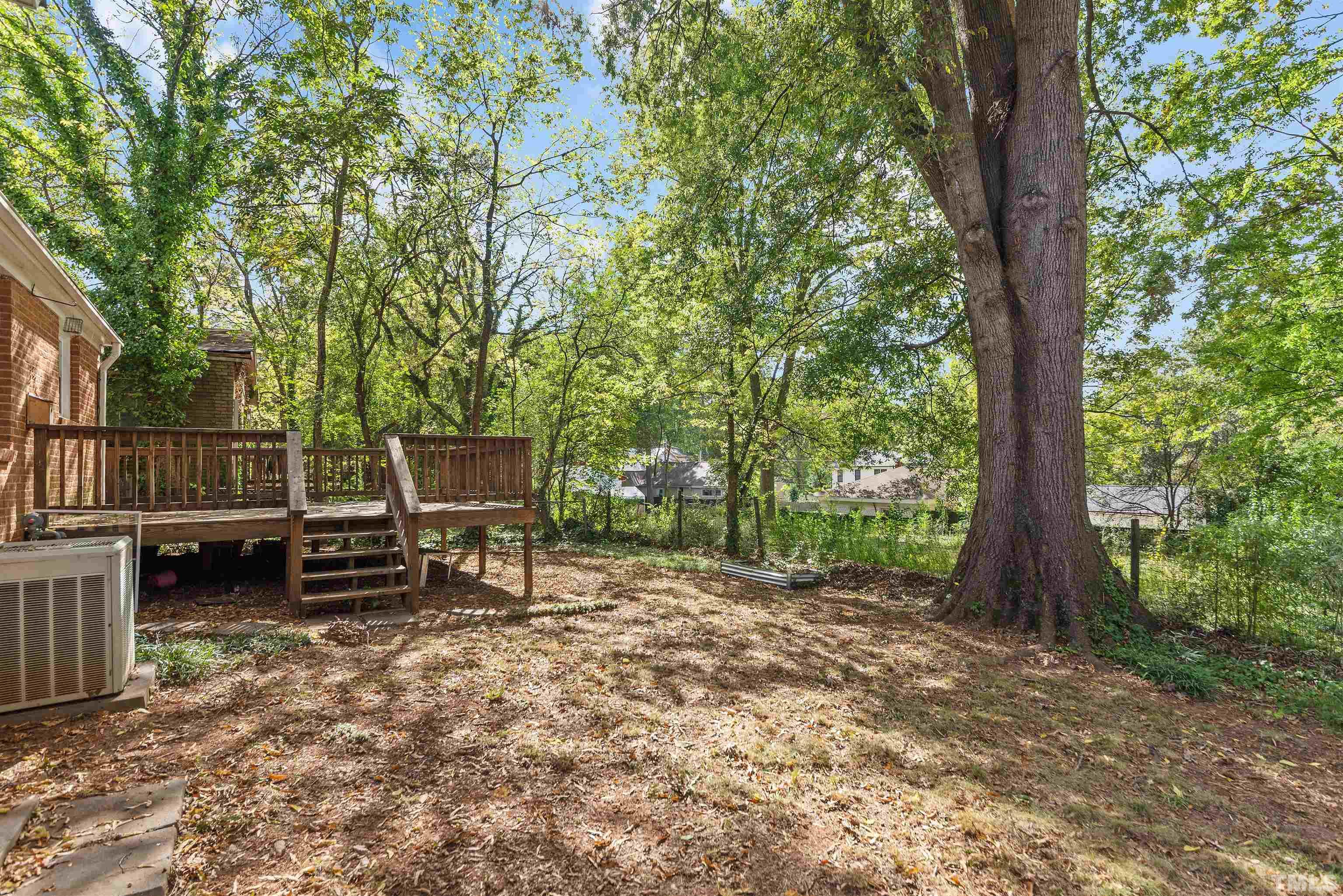 711 Latta Street Raleigh, NC 27607 - Photo 29 of 30 a view of a bench in the backyard with large trees