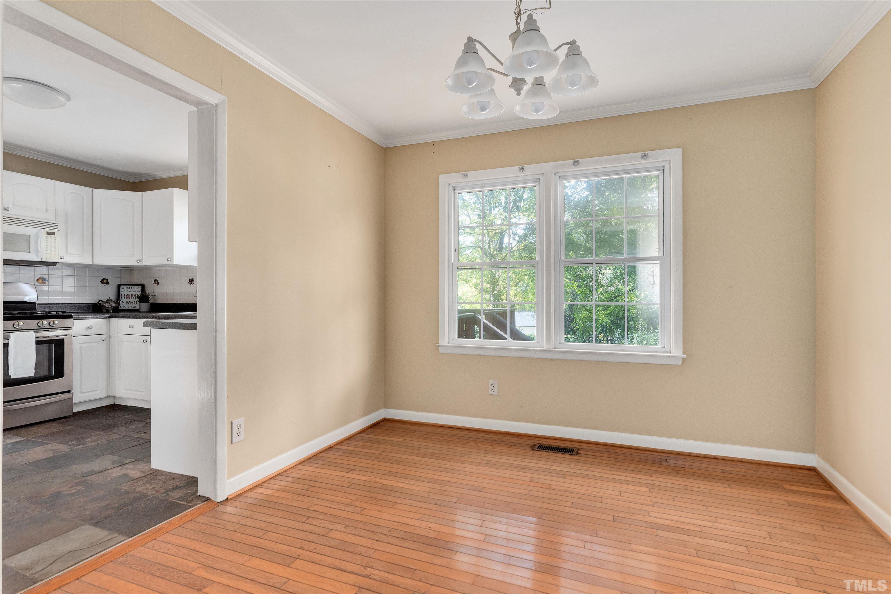 711 Latta Street Raleigh, NC 27607 - Photo 8 of 30 a view of kitchen with wooden floor electronic appliances and window