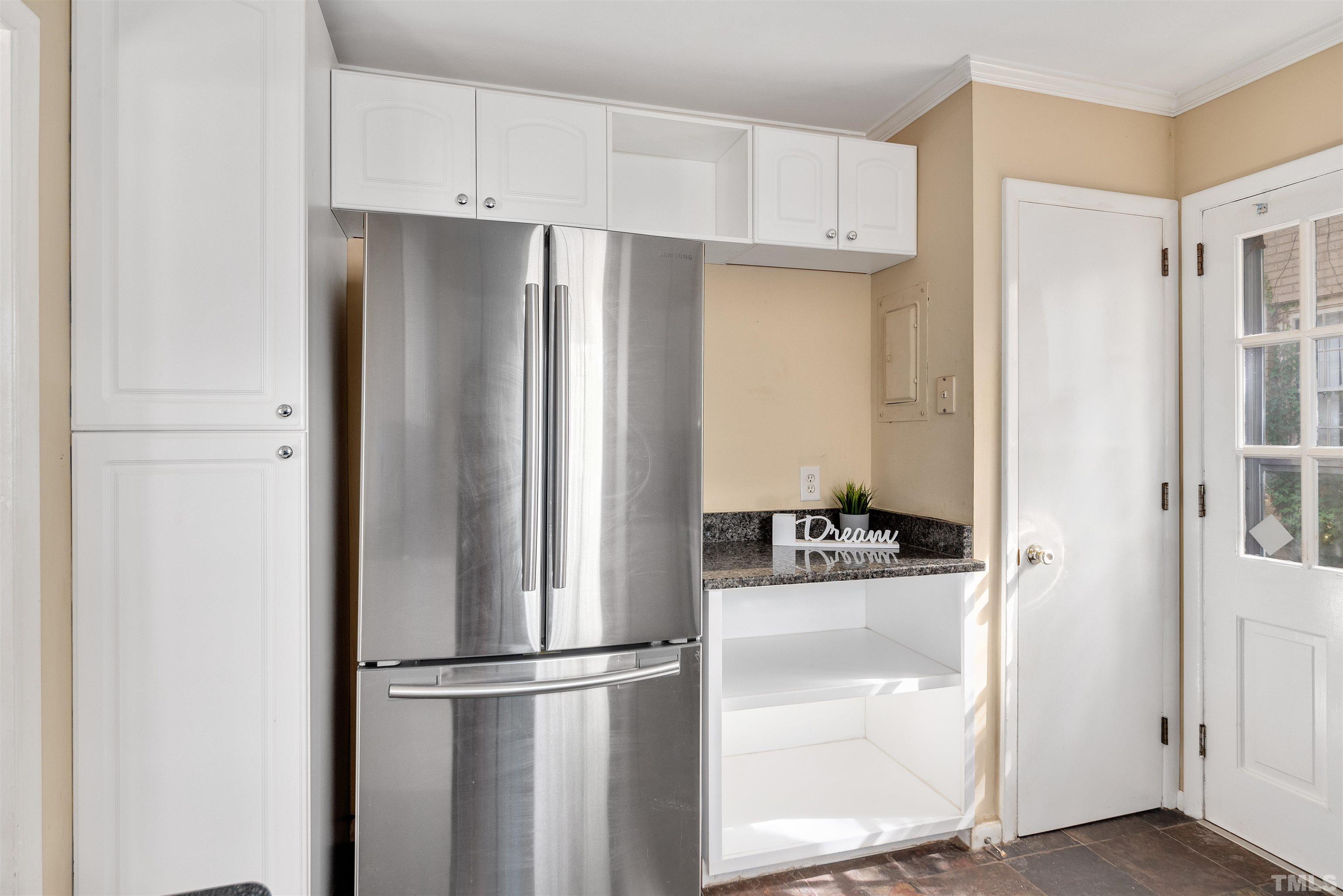 711 Latta Street Raleigh, NC 27607 - Photo 10 of 30 a kitchen with stainless steel appliances a refrigerator and a stove top oven