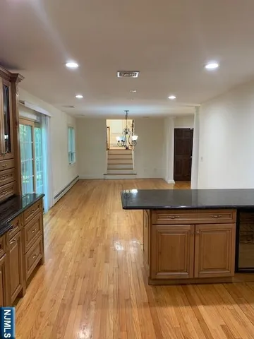 a kitchen with a sink and wooden floor